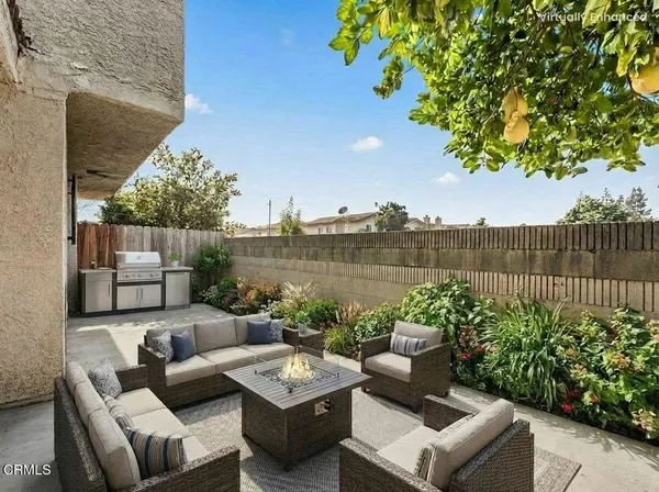 a view of a patio with couches table and chairs and potted plants