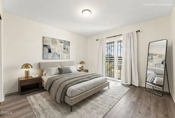 a bedroom with a bed and a large window