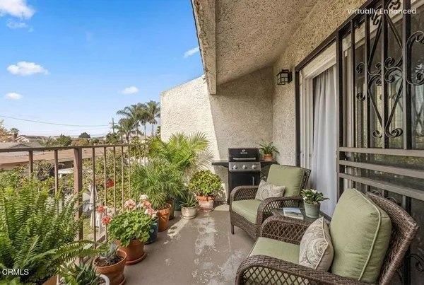 a view of balcony with furniture