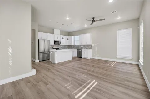 a large kitchen with kitchen island a sink stainless steel appliances and cabinets