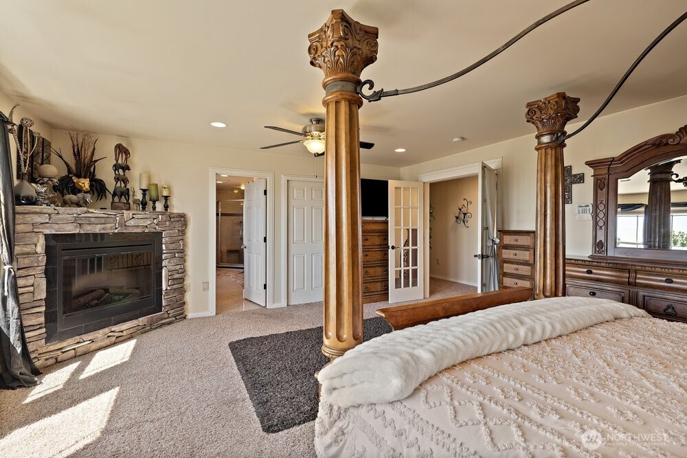 500 St Hilaire Road Yakima, WA 98901 - Photo 16 of 31 a bedroom with a bed and a chandelier