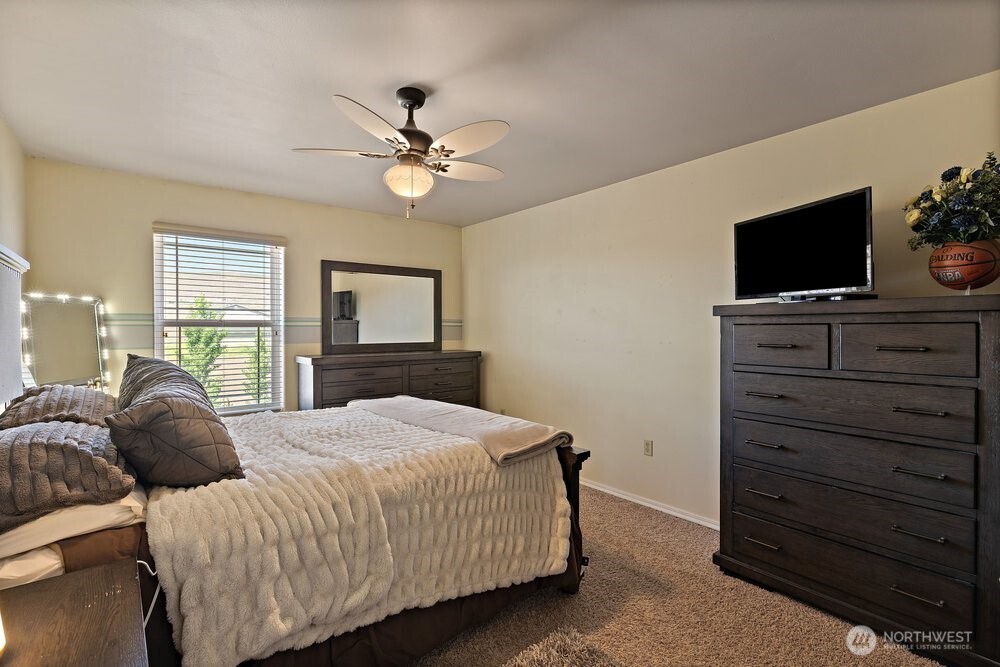 500 St Hilaire Road Yakima, WA 98901 - Photo 17 of 31 a bedroom with a large bed and a flat screen tv