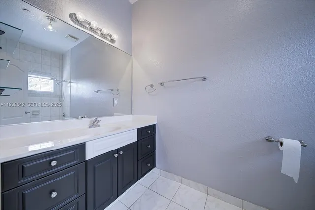 a spacious bathroom with a double vanity sink and a mirror