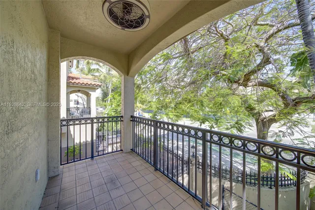 a view of a porch with a floor to ceiling window and outside view