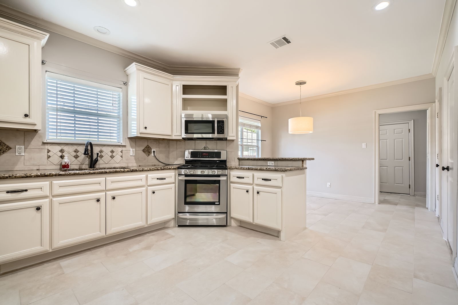 806 East 29th Street Houston, TX 77009 - Photo 11 of 30 a kitchen with stainless steel appliances granite countertop a stove a sink and a refrigerator