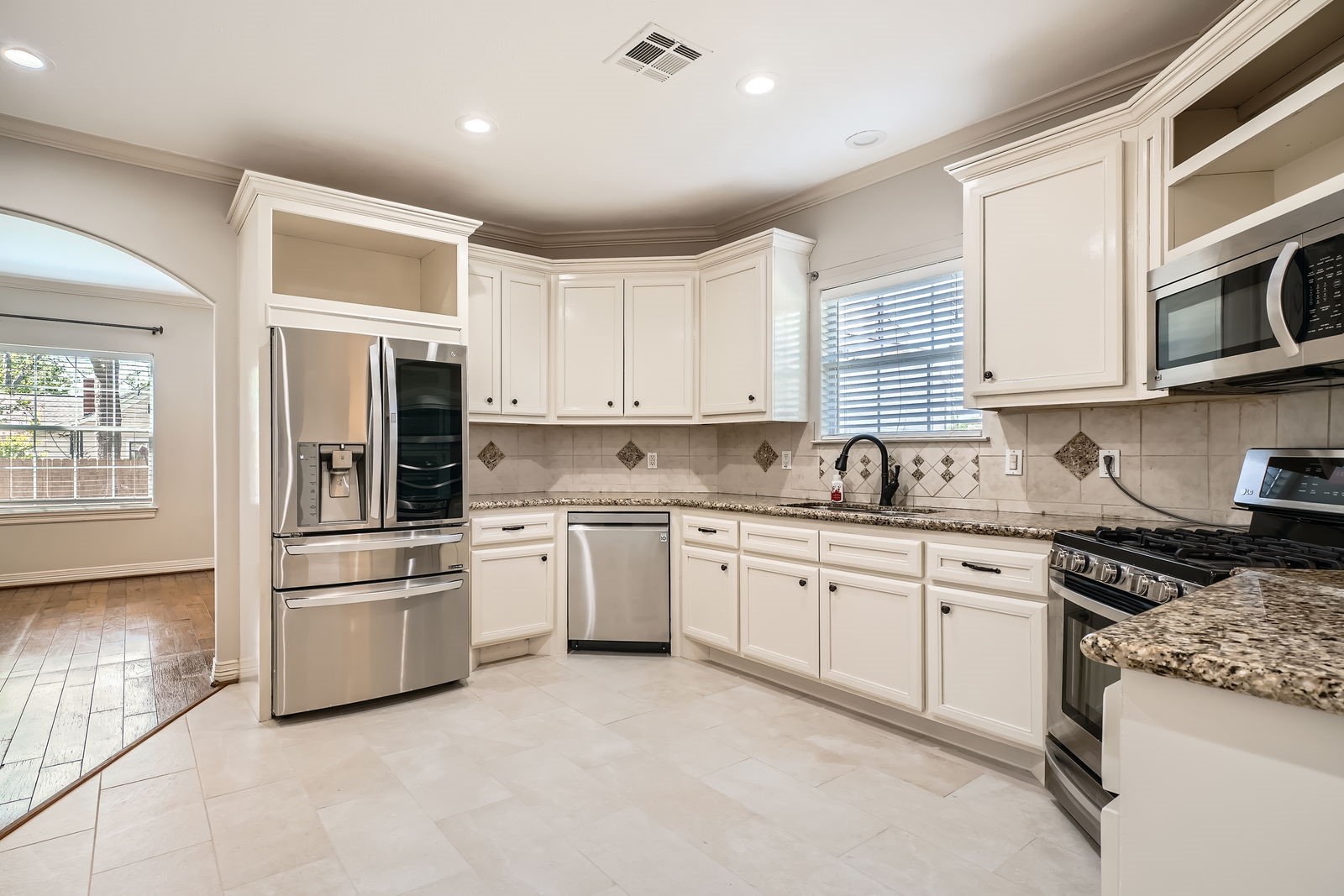 806 East 29th Street Houston, TX 77009 - Photo 12 of 30 a kitchen with granite countertop white cabinets and white stainless steel appliances