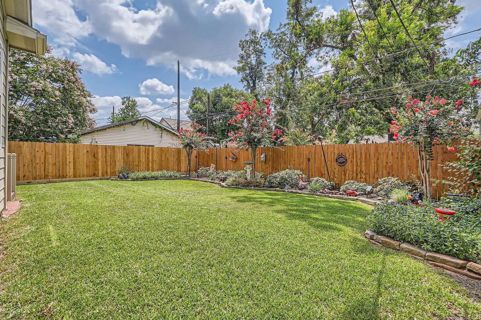 806 East 29th Street Houston, TX 77009 - Photo 25 of 30 a view of a backyard with potted plants and wooden fence