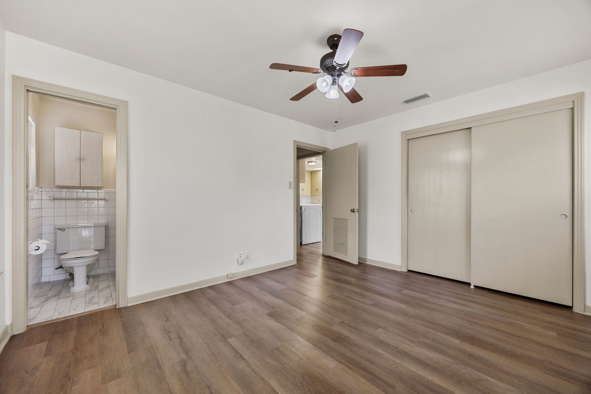 1702 Ridgemont Drive Austin, TX 78723 - Photo 11 of 18 Gleaming wood flooring complements the neutral trim and functional design of this versatile bedroom.