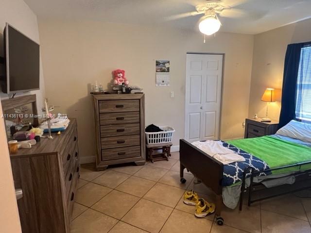 Goulds Miami, FL 33170 - Photo 11 of 18 a bedroom with a bed and a flat tv screen on dresser