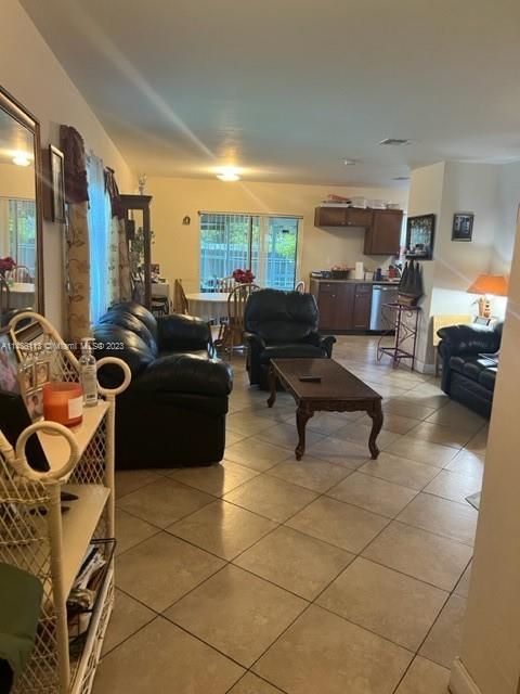 Goulds Miami, FL 33170 - Photo 8 of 18 a living room with furniture a flat screen tv and a window