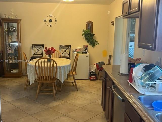 Goulds Miami, FL 33170 - Photo 9 of 18 a dining room with furniture and a chandelier