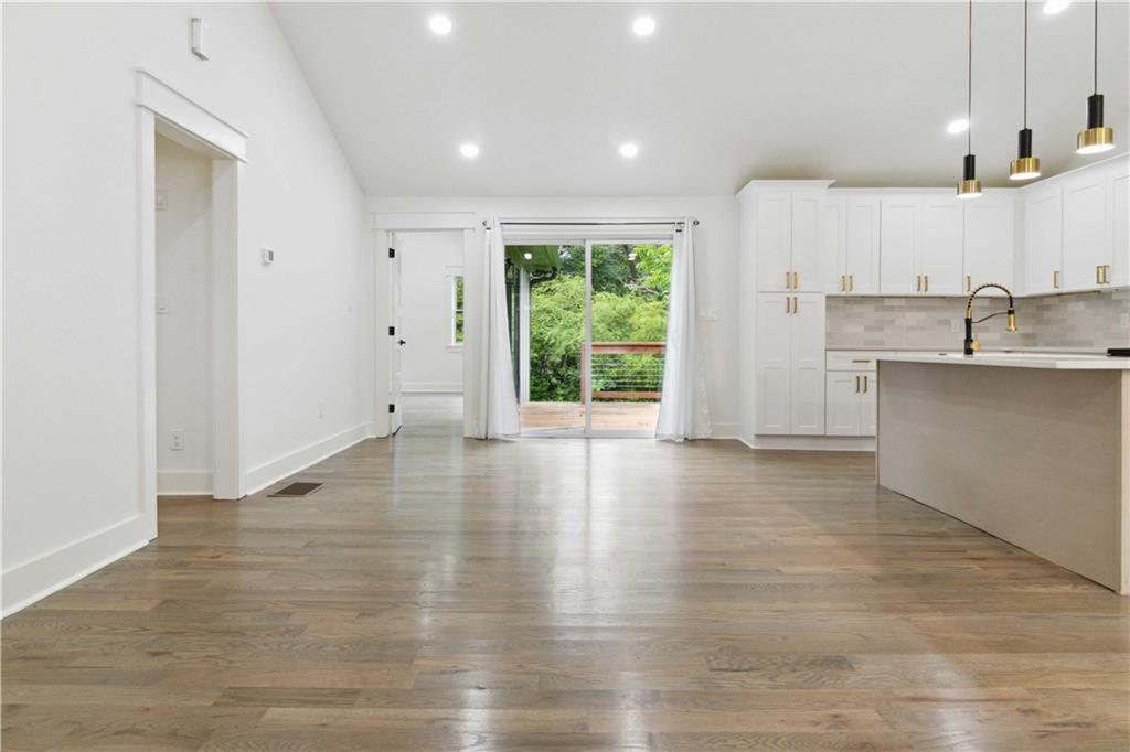 3435 Maplehurst Drive Decatur, GA 30032 - Photo 11 of 39 an empty room with wooden floor and windows