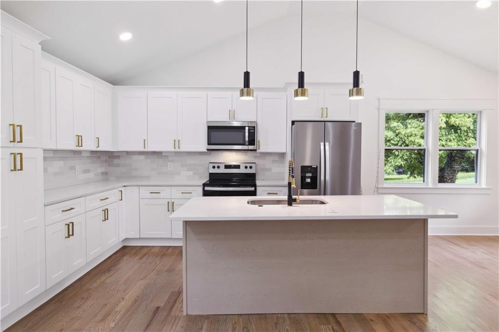 3435 Maplehurst Drive Decatur, GA 30032 - Photo 13 of 39 a kitchen with stainless steel appliances a stove a sink a refrigerator a center island and wooden cabinets