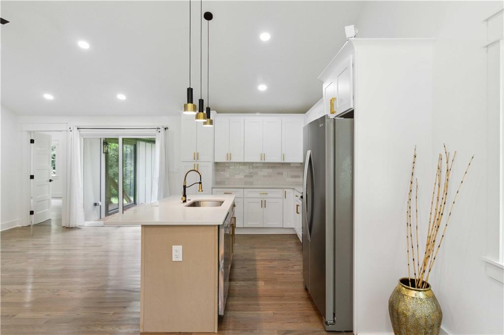 3435 Maplehurst Drive Decatur, GA 30032 - Photo 15 of 39 a kitchen with stainless steel appliances granite countertop a sink a refrigerator and a window