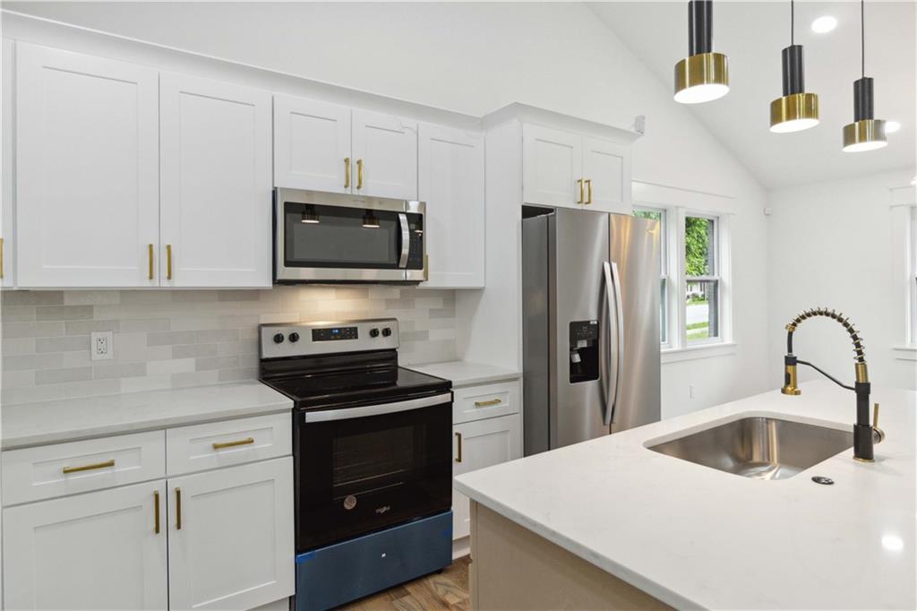 3435 Maplehurst Drive Decatur, GA 30032 - Photo 17 of 39 a kitchen with a sink a stove and refrigerator