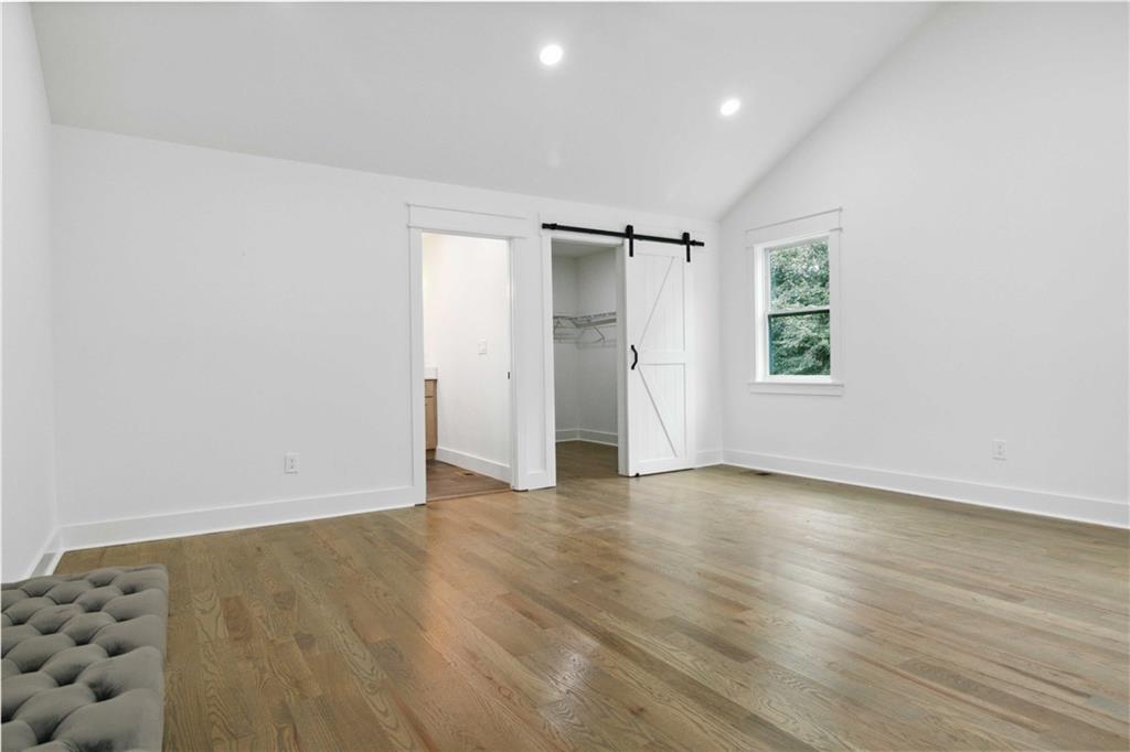3435 Maplehurst Drive Decatur, GA 30032 - Photo 18 of 39 an empty room with wooden floor and windows