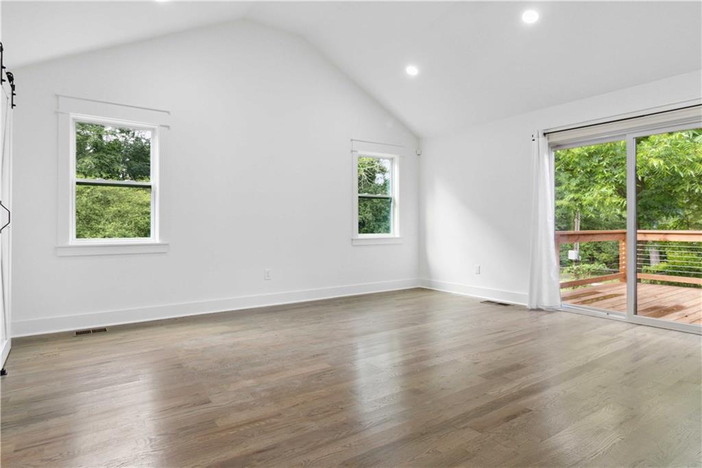 3435 Maplehurst Drive Decatur, GA 30032 - Photo 20 of 39 an empty room with wooden floor and windows