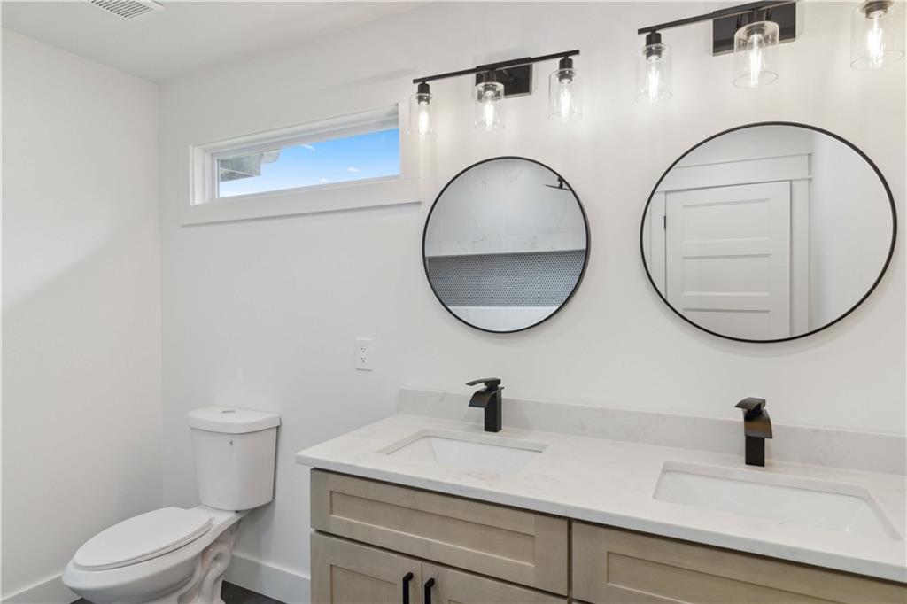 3435 Maplehurst Drive Decatur, GA 30032 - Photo 21 of 39 a bathroom with a toilet and a mirror