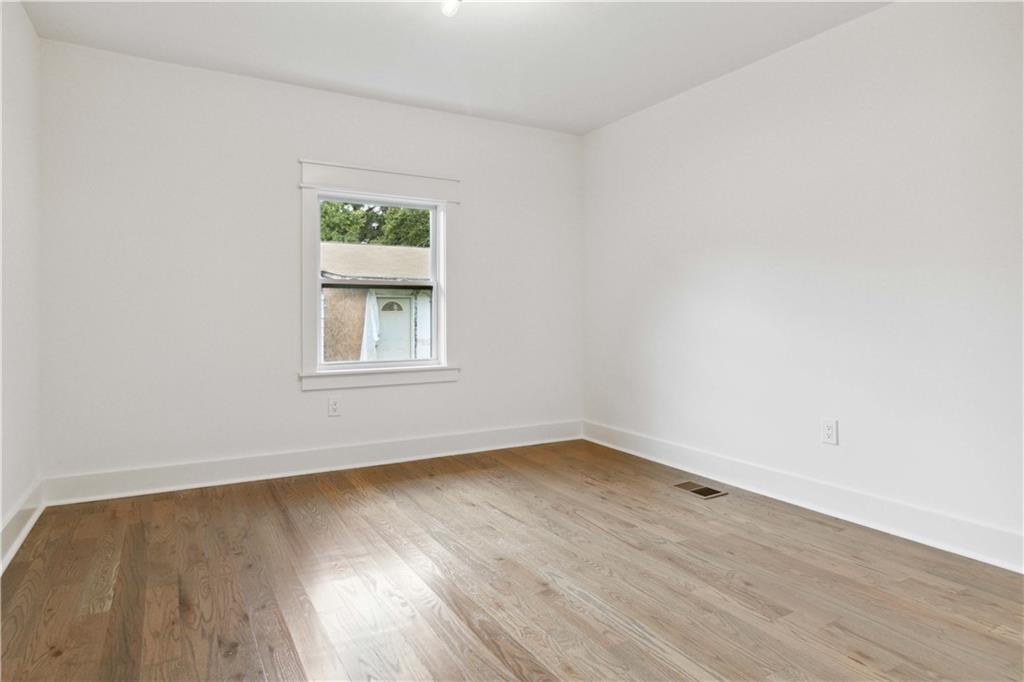 3435 Maplehurst Drive Decatur, GA 30032 - Photo 24 of 39 an empty room with wooden floor and windows