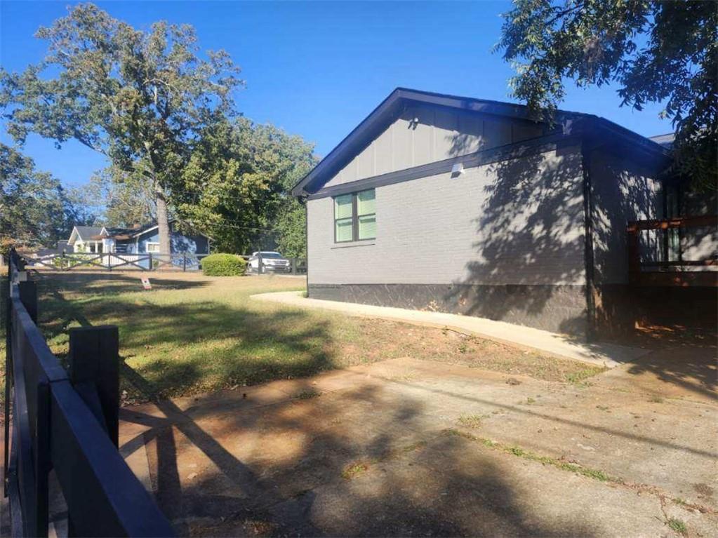 3435 Maplehurst Drive Decatur, GA 30032 - Photo 35 of 39 a backyard of a house with table and chairs under an umbrella
