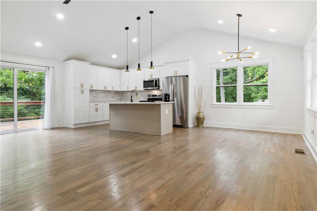 3435 Maplehurst Drive Decatur, GA 30032 - Photo 4 of 39 a view of a kitchen with stainless steel appliances granite countertop a stove a refrigerator a oven and a wooden floors