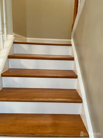 a view of a refrigerator in kitchen and wooden floor