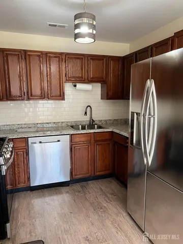 a kitchen with wooden cabinets and a stove top oven