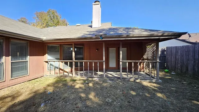 a view of a house with a wooden deck