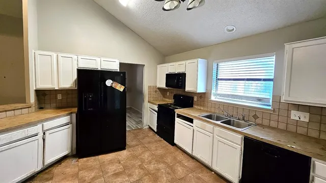 a kitchen with a refrigerator stove and sink