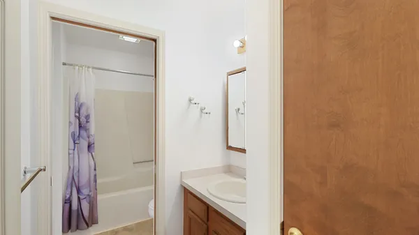 a bathroom with a shower a toilet and a sink