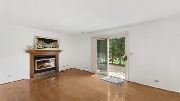 a view of an empty room with window and fire place
