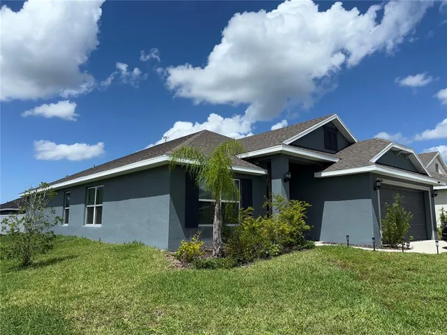 a front view of house with yard and trees