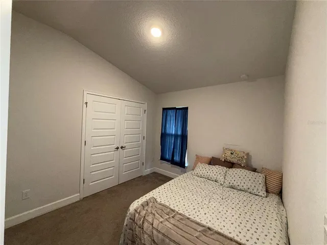 a bedroom with a bed and dresser