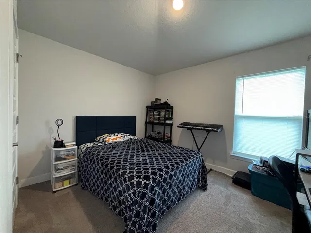 a bedroom with a bed and window