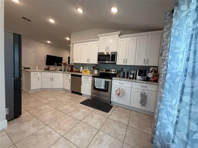 a view of a living room kitchen and a window