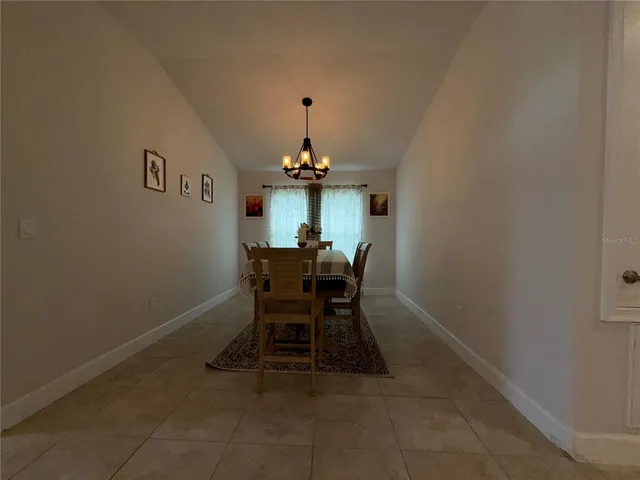 a dining room with furniture and chandelier