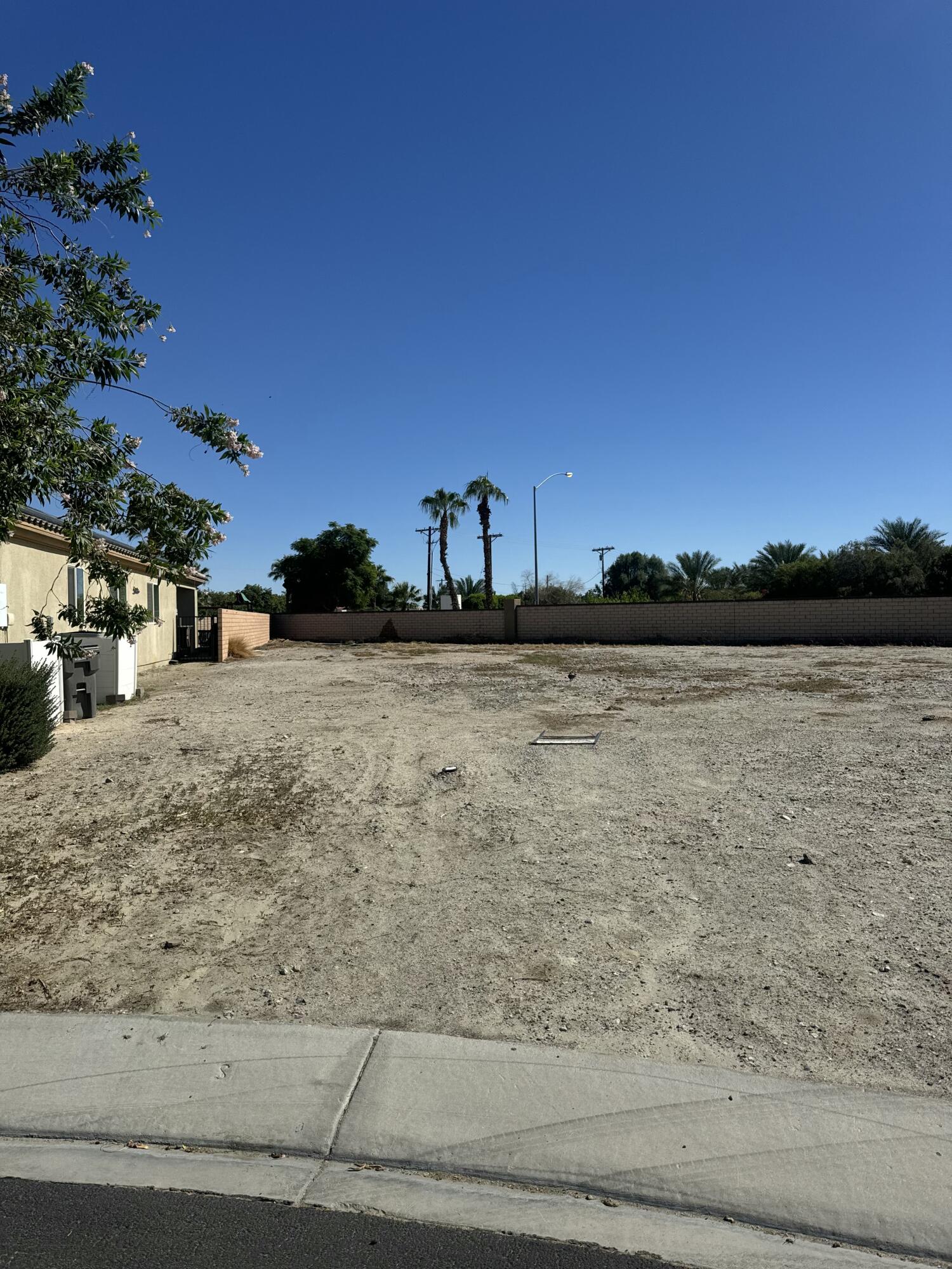 0 DeVito Court Indio, CA 92201 - Photo 2 of 3 a view of swimming pool with an outdoor space and seating area