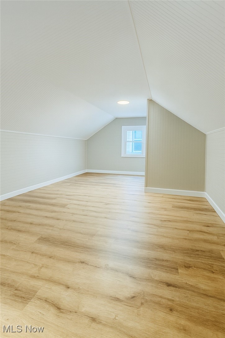 14505 Triskett Road Cleveland, OH 44111 - Photo 8 of 15 Bonus room featuring light wood-type flooring and lofted ceiling
