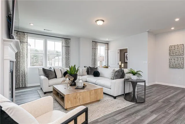 a living room with furniture and wooden floor