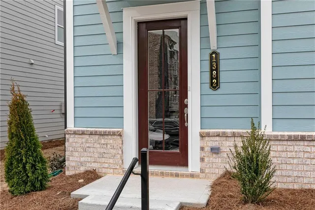 a view of front door and potted plants