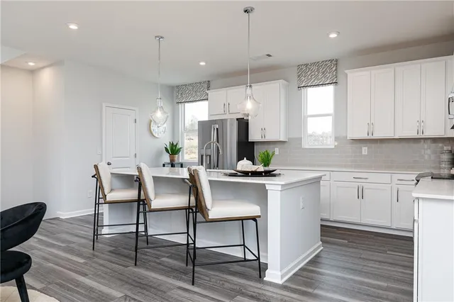 a kitchen with a table chairs stove and microwave