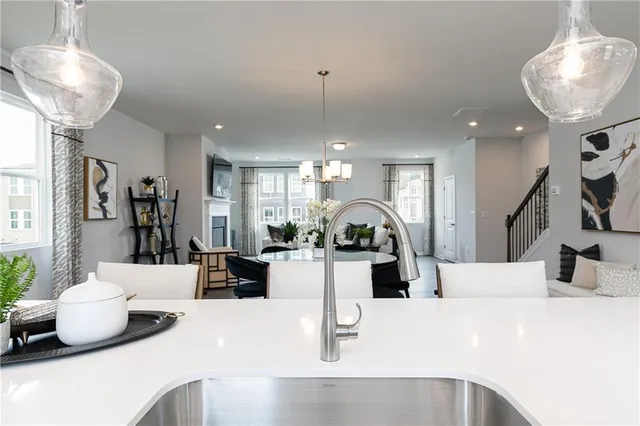 a kitchen with stainless steel appliances kitchen island granite countertop a table and chairs in it