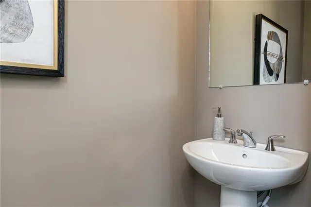 a bathroom with a sink a mirror and a window