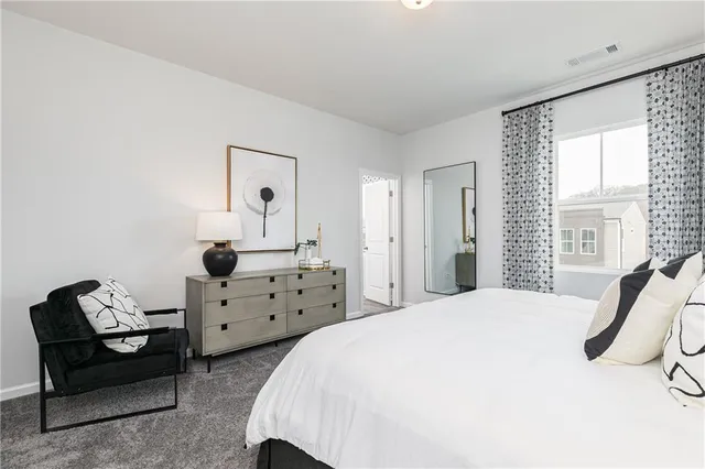 a bedroom with a bed and a dresser in it