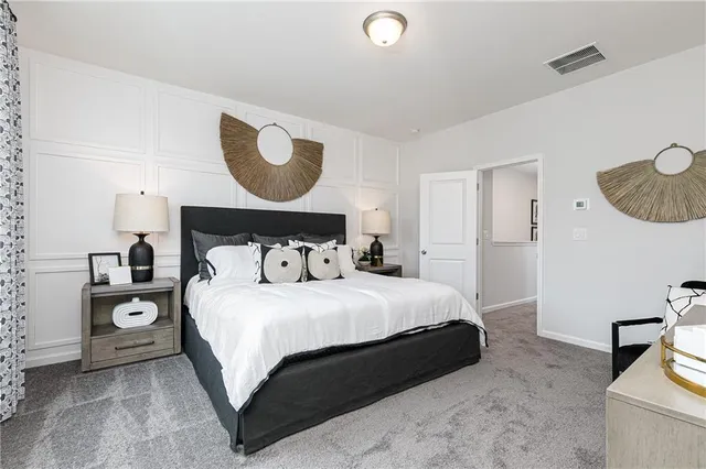 a bedroom with a bed and a painting on the wall