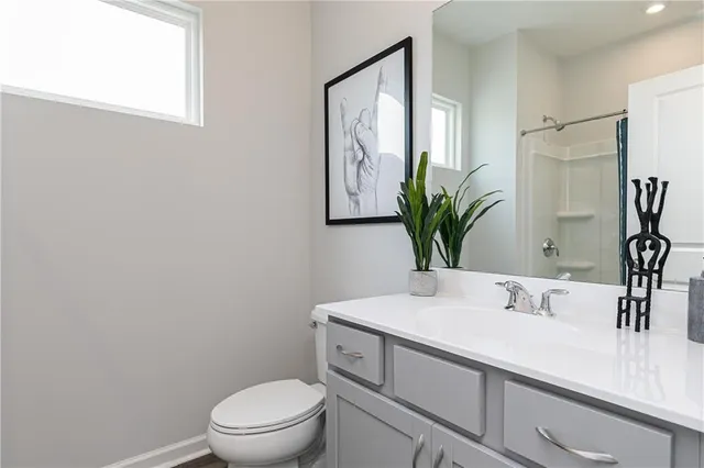 a bathroom with a sink a toilet and mirror