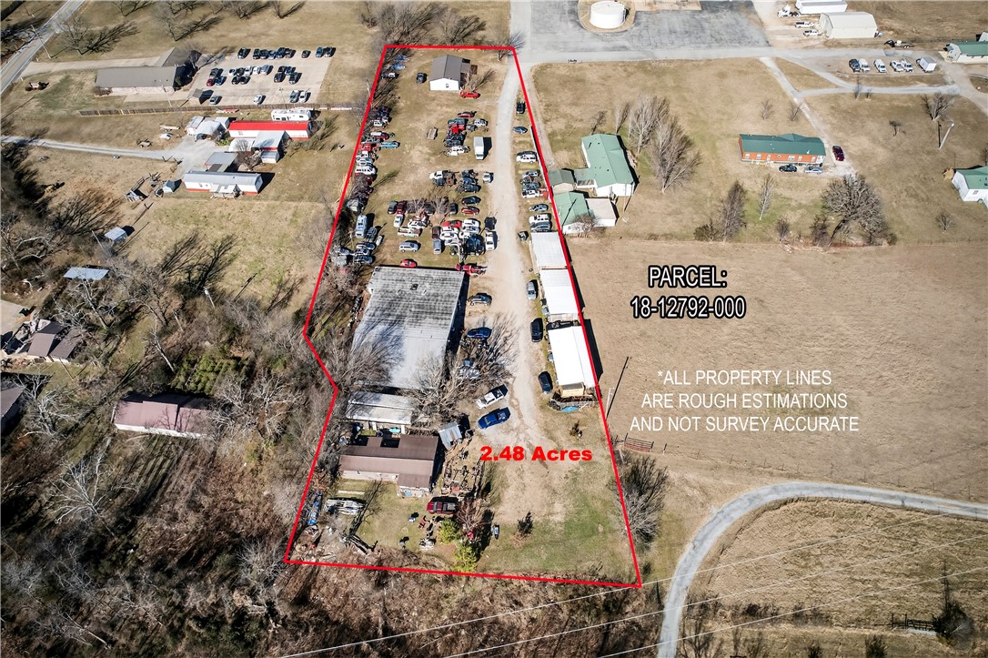 17374 Heavy Chevy Road Siloam Springs, AR 72761 - Photo 32 of 40 Aerial overview of property's location with property parcel outlined wih barndominium, junk yard, automotive shop and mobile home