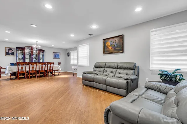 a living room with furniture and a book shelf