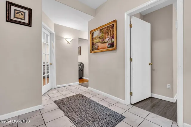a view of a hallway view with wooden floor and dining room