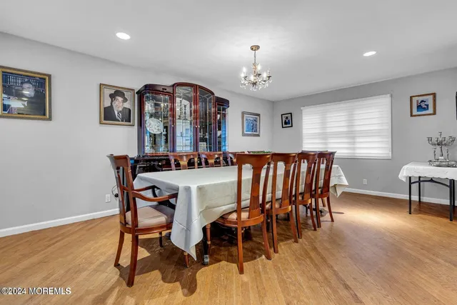 a view of a a dining room with furniture window and wooden floor